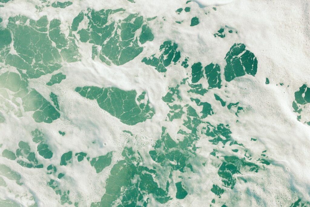 Turquoise water with white foam patterns