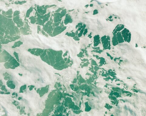 Turquoise water with white foam patterns