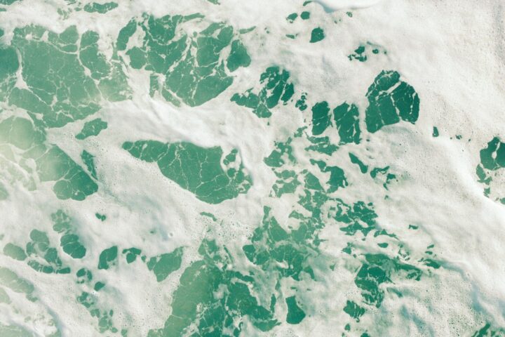 Turquoise water with white foam patterns